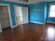 Large bedroom with hardwood floors and natural light offers storage solutions at 29 Willow St, Badin, NC 28009