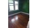 This bedroom features hardwood floors and large windows that let in lots of natural light at 29 Willow St, Badin, NC 28009