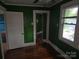Cozy bedroom with green walls, natural light from the windows, and classic hardwood flooring at 29 Willow St, Badin, NC 28009