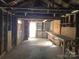Interior view of the detached garage with exposed studs and a workbench at 29 Willow St, Badin, NC 28009