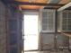 Interior of garage with a small storage closet and exterior access door at 29 Willow St, Badin, NC 28009