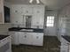 Kitchen featuring a double sink, ample cabinetry, and tile backsplash at 29 Willow St, Badin, NC 28009