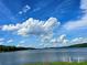 Scenic view of a lake with clear blue skies and fluffy white clouds at 29 Willow St, Badin, NC 28009