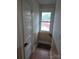 Landing area with a window offering natural light and views, complemented by a door to the left at 29 Willow St, Badin, NC 28009