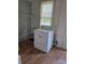 A basic laundry room with a window and clothes dryer at 29 Willow St, Badin, NC 28009
