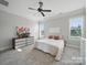 Bright bedroom with a ceiling fan and two windows providing natural light at 3007 Arsdale Rd, Waxhaw, NC 28173