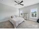 Bright bedroom featuring neutral walls, carpeted floors, a ceiling fan, and two large windows at 3007 Arsdale Rd, Waxhaw, NC 28173