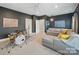 Spacious bonus room with gray sectional sofa and drum set at 3007 Arsdale Rd, Waxhaw, NC 28173