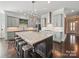 Spacious kitchen with gray cabinets, granite counters, and a large island with seating at 3007 Arsdale Rd, Waxhaw, NC 28173