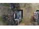 An aerial view of a house with a dark gray roof, surrounded by dormant trees on a sunny day at 305 E Henry St, Belmont, NC 28012