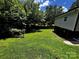 Spacious backyard with lush lawn and mature trees, perfect for outdoor activities and relaxation at 305 E Henry St, Belmont, NC 28012