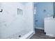 Bright bathroom features sleek, modern walk-in shower, vanity and gray plank flooring at 305 E Henry St, Belmont, NC 28012