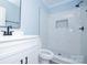 Updated bathroom features a modern vanity and a luxurious, tiled walk-in shower at 305 E Henry St, Belmont, NC 28012