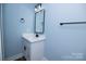 Stylish bathroom features vanity with modern fixtures, complemented by sleek black accessories at 305 E Henry St, Belmont, NC 28012