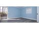 Comfortable bedroom with neutral paint, gray floors, and a door to the back deck at 305 E Henry St, Belmont, NC 28012