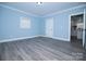 Spacious bedroom with natural light, featuring gray wood floors and neutral paint at 305 E Henry St, Belmont, NC 28012