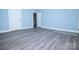 Comfortable bedroom with neutral paint, gray wood floors, and a walk-in closet at 305 E Henry St, Belmont, NC 28012