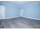 Inviting bedroom featuring natural light, gray floors and neutral paint at 305 E Henry St, Belmont, NC 28012
