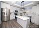 Modern kitchen with white cabinets, stainless steel appliances, and center island at 305 E Henry St, Belmont, NC 28012