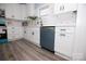 Modern kitchen featuring a stainless steel dishwasher and white cabinets at 305 E Henry St, Belmont, NC 28012