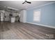 Bright, open-concept living area featuring modern flooring and a view into the stylish, renovated kitchen at 305 E Henry St, Belmont, NC 28012