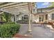 Serene backyard patio with white pergola, lush landscaping, and outdoor seating perfect for entertaining at 327 Saint Andrews Rd, Statesville, NC 28625