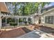 Charming backyard with pergola-covered patio, mature landscaping, and cozy seating areas at 327 Saint Andrews Rd, Statesville, NC 28625