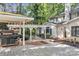 Private backyard with a deck, patio area, grill, and lush greenery, perfect for outdoor enjoyment at 327 Saint Andrews Rd, Statesville, NC 28625