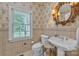 Elegant bathroom with a pedestal sink, floral wallpaper, and a window offering natural light at 327 Saint Andrews Rd, Statesville, NC 28625
