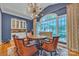 Stunning dining room with a beautiful chandelier, custom built-ins, and a picturesque view of the outdoors at 327 Saint Andrews Rd, Statesville, NC 28625