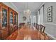 Expansive dining room featuring a large wooden table, hutch, chandelier, and hardwood floors at 327 Saint Andrews Rd, Statesville, NC 28625