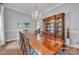 Formal dining room with a large wooden table, crystal chandelier, and hardwood floors at 327 Saint Andrews Rd, Statesville, NC 28625