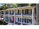 Close up of stately home with white columns, black shutters, iron railings, and red door at 327 Saint Andrews Rd, Statesville, NC 28625