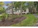 White home with lush landscaping and a unique architectural design at 327 Saint Andrews Rd, Statesville, NC 28625