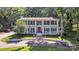 Stately two-story home with white columns, balcony, red front door and mature trees at 327 Saint Andrews Rd, Statesville, NC 28625