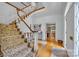 Spacious foyer with staircase and hardwood floors leading to a cozy office with a fireplace at 327 Saint Andrews Rd, Statesville, NC 28625
