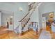 Elegant foyer features hardwood floors, a classic staircase, and stylish decor at 327 Saint Andrews Rd, Statesville, NC 28625