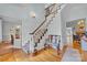 Grand foyer with a staircase and hardwood floors that lead to a formal dining room and living room at 327 Saint Andrews Rd, Statesville, NC 28625