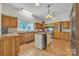 Classic kitchen with wooden cabinets, tile floors, center island, and stainless steel appliances at 327 Saint Andrews Rd, Statesville, NC 28625