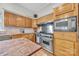 Gourmet kitchen boasts a professional-grade range, granite counters, and custom wood cabinetry at 327 Saint Andrews Rd, Statesville, NC 28625