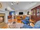 Open-concept living room with fireplace, hardwood floors, and comfortable seating area at 327 Saint Andrews Rd, Statesville, NC 28625