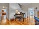 Elegant living room featuring a grand piano and access to the kitchen and doorway to the outside at 327 Saint Andrews Rd, Statesville, NC 28625