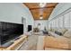 Cozy living room with wood ceiling, a comfortable sofa, and a large TV, perfect for relaxing and entertainment at 327 Saint Andrews Rd, Statesville, NC 28625