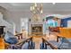 Cozy living room featuring a marble fireplace, stylish decor, and hardwood floors at 327 Saint Andrews Rd, Statesville, NC 28625