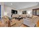 Spacious living room featuring hardwood floors, comfortable seating, and a large entertainment center at 327 Saint Andrews Rd, Statesville, NC 28625