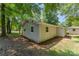 The backyard view shows the side exterior of the house surrounded by nature at 3724 Patricia Nw Dr, Concord, NC 28027