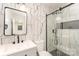 This bathroom has marble wall tiles, black fixtures, and a glass-door shower at 3724 Patricia Nw Dr, Concord, NC 28027