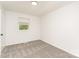 A bedroom with neutral carpet, a window, and white walls provides a blank canvas at 3724 Patricia Nw Dr, Concord, NC 28027