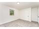 A bedroom features a window, door, and neutral carpet against crisp white walls at 3724 Patricia Nw Dr, Concord, NC 28027