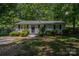 Charming single-story home with a landscaped front yard, gray siding, and dark shutters at 3724 Patricia Nw Dr, Concord, NC 28027